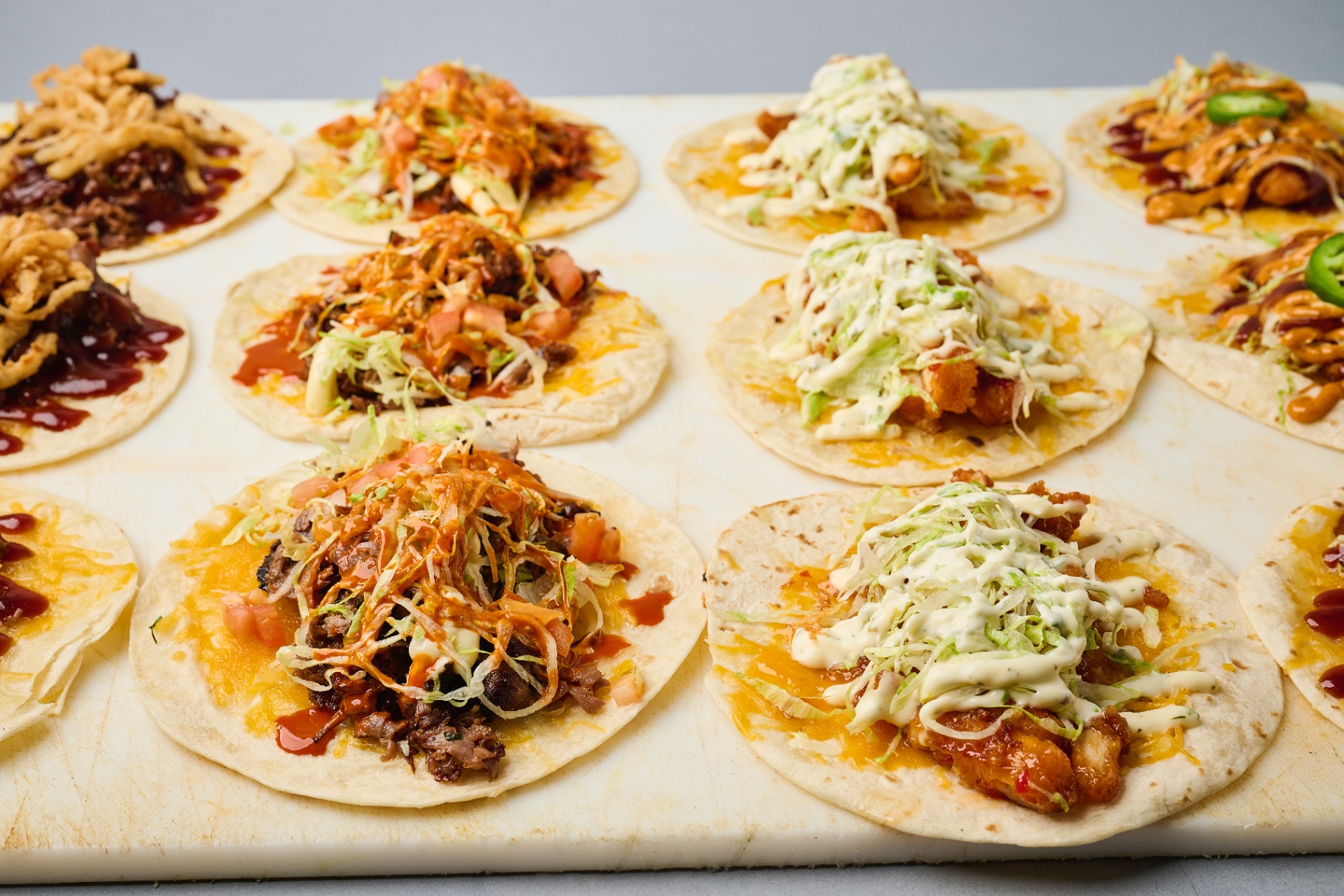 Lineup of late-night street tacos loaded with brisket, chicken, and bold sauces